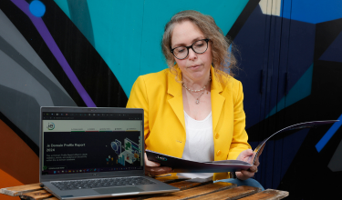 Annual Reports Melissa with the DPR Report 2024 and a laptop